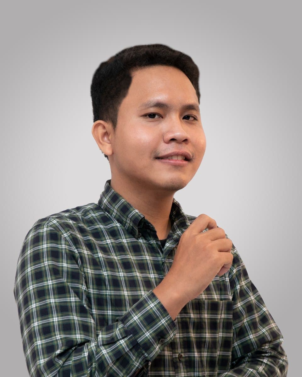 Portrait of Raja Saputera in a green checked shirt